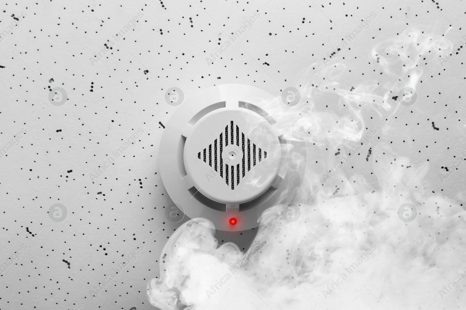 Fire alarm system. Detector on ceiling triggered by smoke, bottom view Image of Fire alarm system. Detector on ceiling triggered by smoke, bottom view
