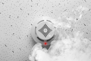 Image of Fire alarm system. Detector on ceiling triggered by smoke, bottom view