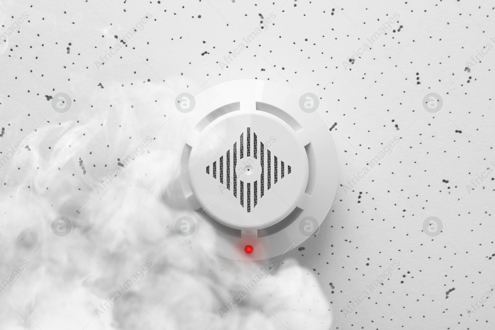 Fire alarm system. Detector on ceiling triggered by smoke, bottom view Image of Fire alarm system. Detector on ceiling triggered by smoke, bottom view