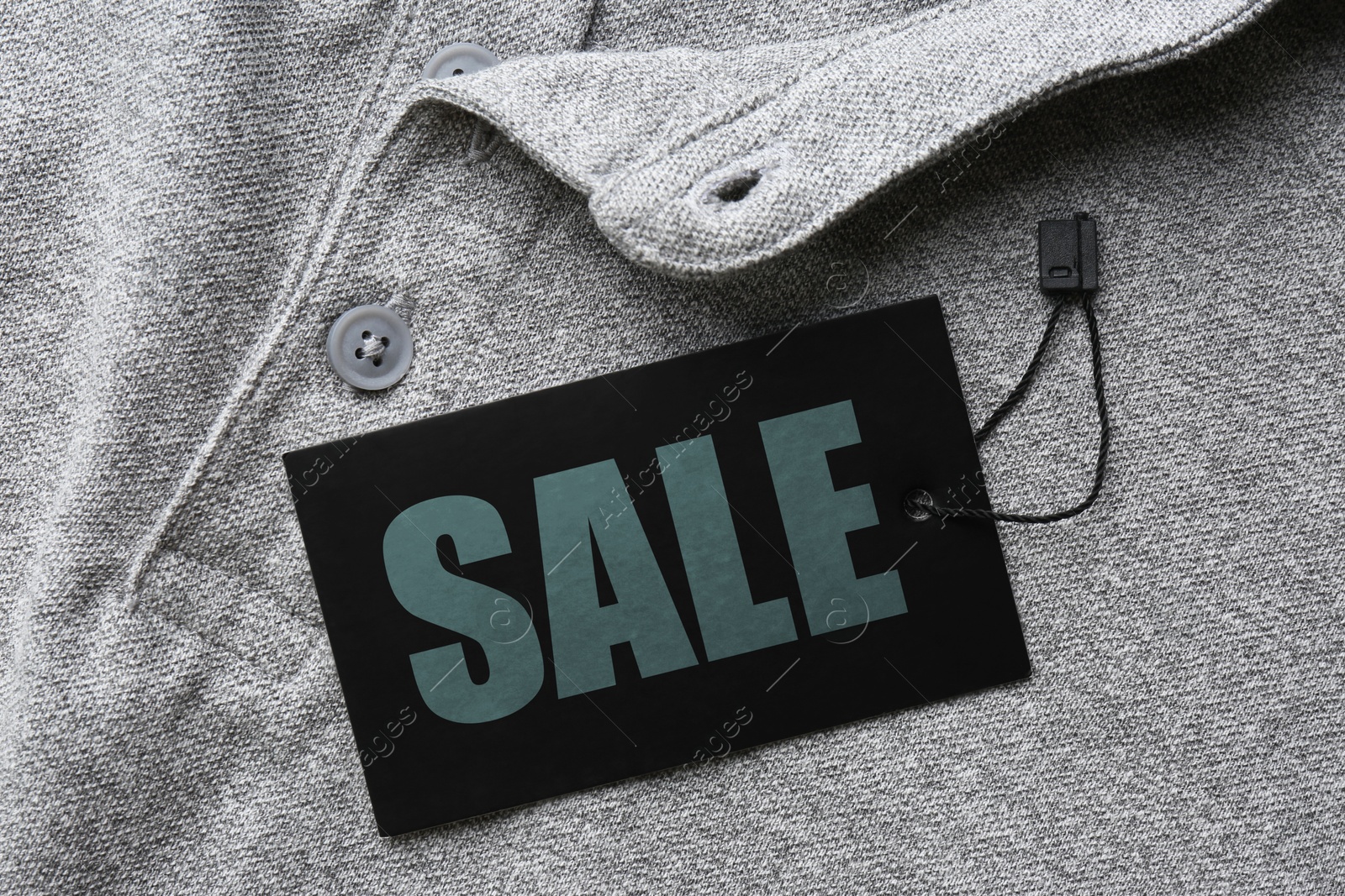 Black Sale tag on grey shirt, top view Image of Black Sale tag on grey shirt, top view