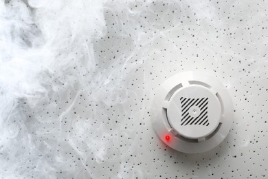 Image of Fire alarm system. Detector on ceiling triggered by smoke, bottom view