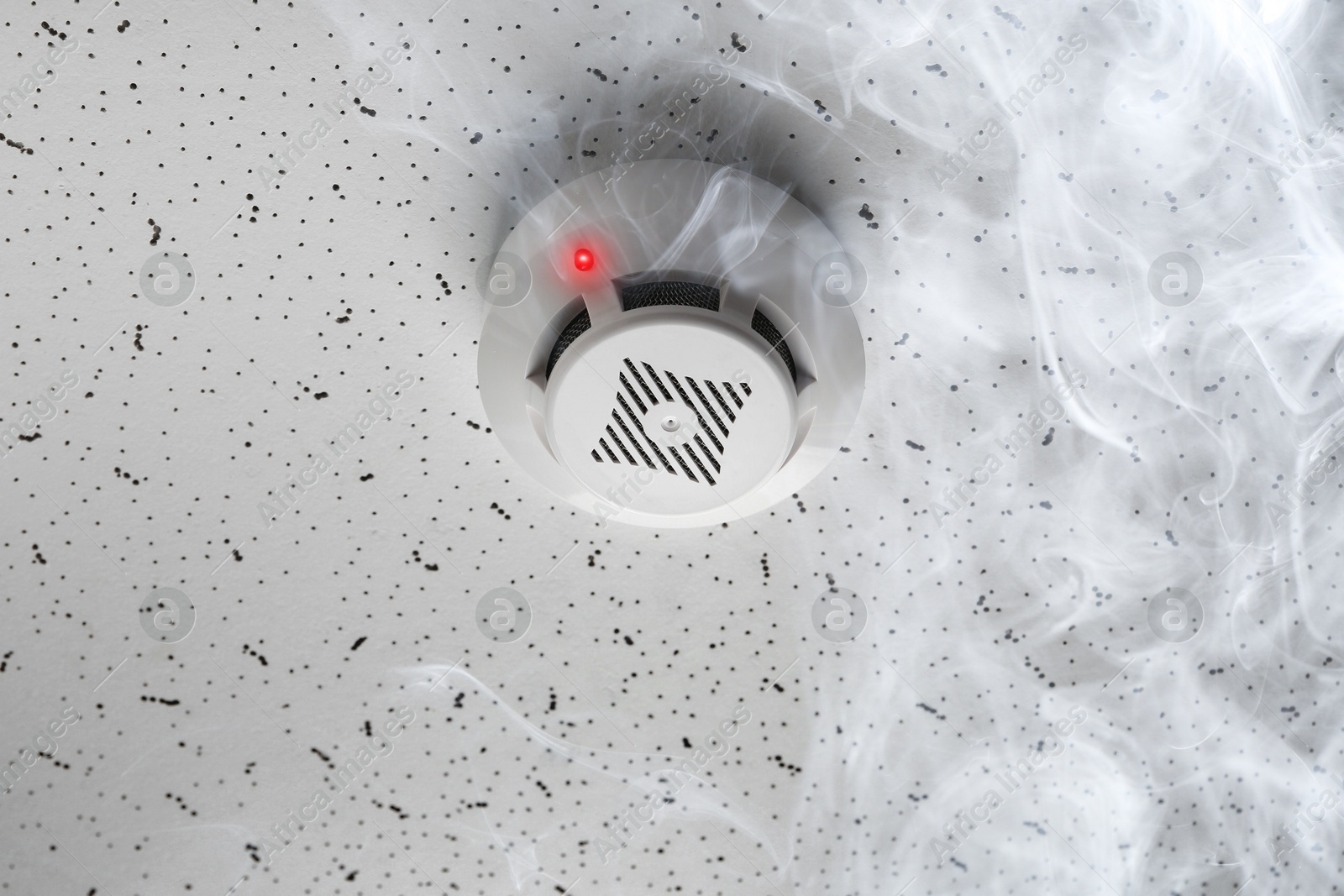 Fire alarm system. Detector on ceiling triggered by smoke Image of Fire alarm system. Detector on ceiling triggered by smoke