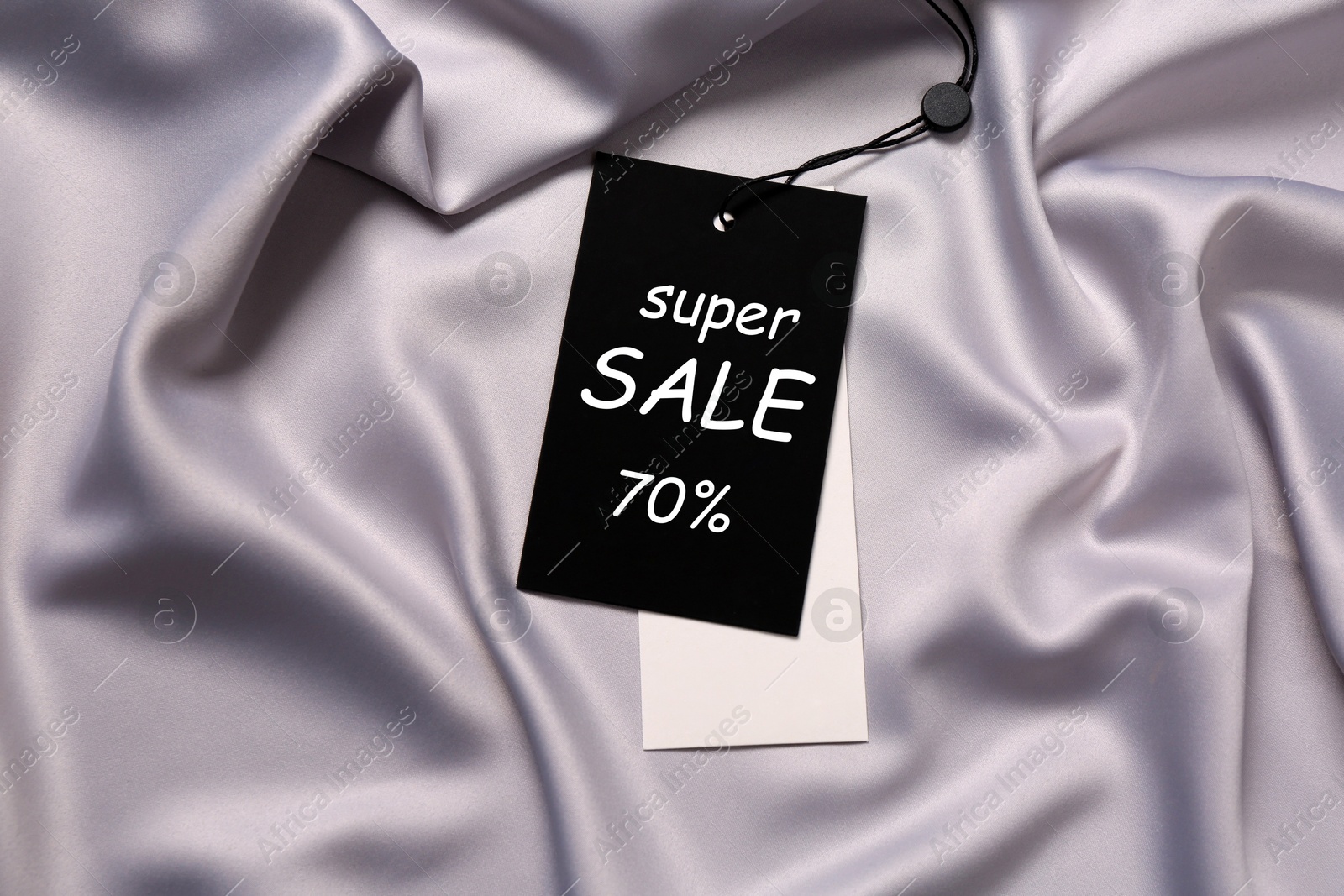 Black Sale tag on silk skirt, top view Image of Black Sale tag on silk skirt, top view