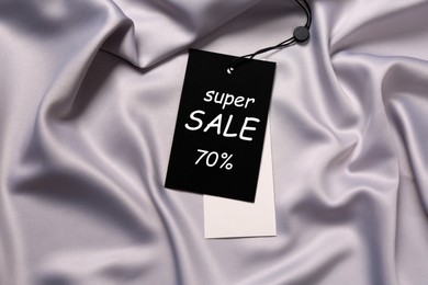 Image of Black Sale tag on silk skirt, top view