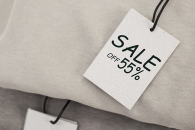 Image of White Sale tag on clothing, top view