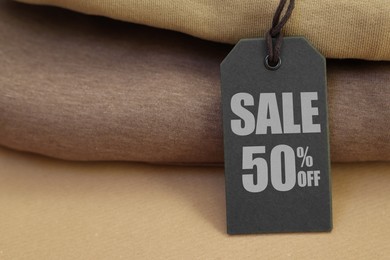 Image of Black Sale tag and clothes, closeup view
