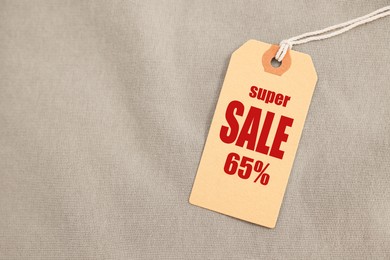 Image of Beige Sale tag on clothing, top view