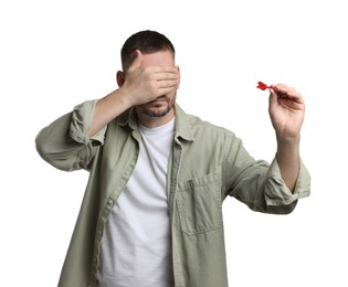 Photo of Targeting. Man with dart covering eyes on white background