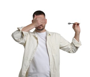 Photo of Targeting. Man with dart covering eyes on white background