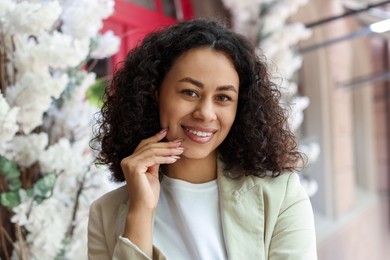 Photo of Portrait of smiling Latin American woman outdoors