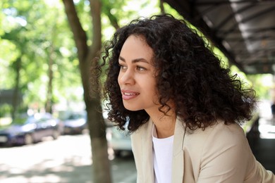 Photo of Portrait of smiling Latin American woman outdoors
