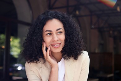 Photo of Portrait of smiling Latin American woman outdoors