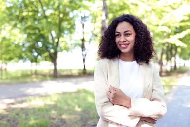 Photo of Portrait of smiling Latin American woman outdoors. Space for text