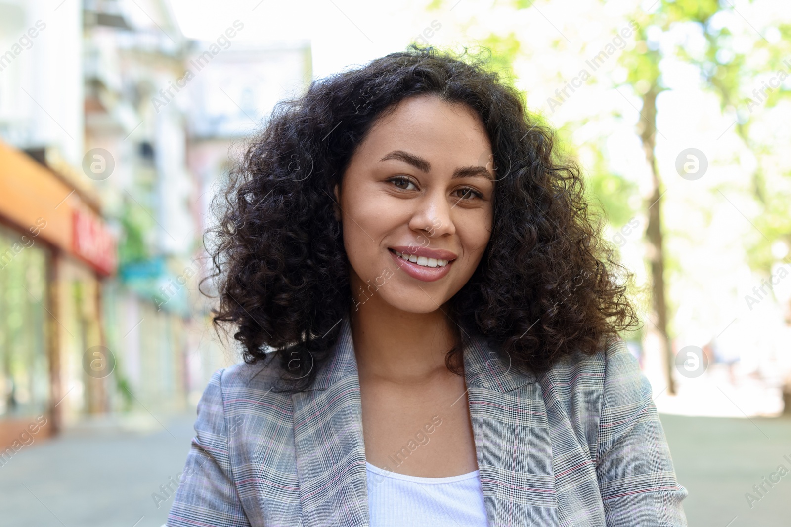 Photo of Portrait of smiling Latin American woman outdoors