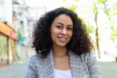 Photo of Portrait of smiling Latin American woman outdoors