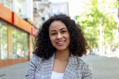 Photo of Portrait of smiling Latin American woman outdoors