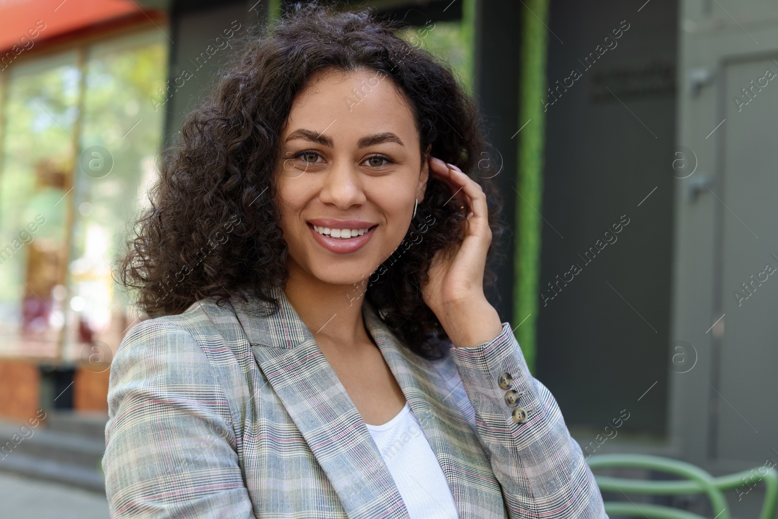 Photo of Portrait of smiling Latin American woman outdoors