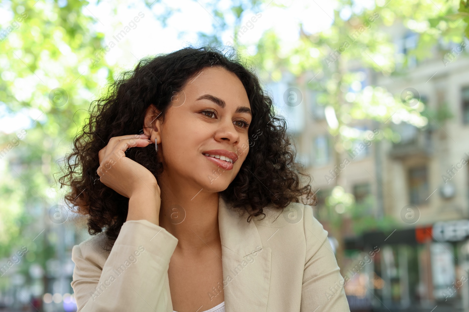 Photo of Portrait of smiling Latin American woman outdoors