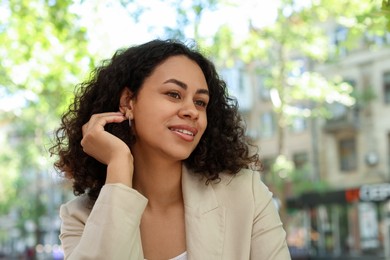 Photo of Portrait of smiling Latin American woman outdoors