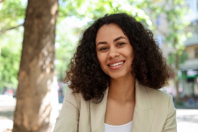 Photo of Portrait of smiling Latin American woman outdoors