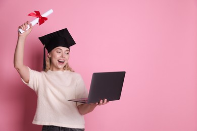 Photo of Happy student with diploma and laptop after graduation on pink background. Space for text