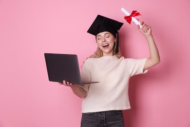 Photo of Happy student with diploma and laptop after graduation on pink background