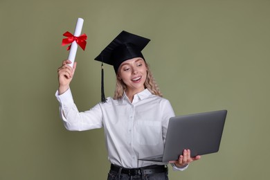 Photo of Happy student with diploma and laptop after graduation on green background