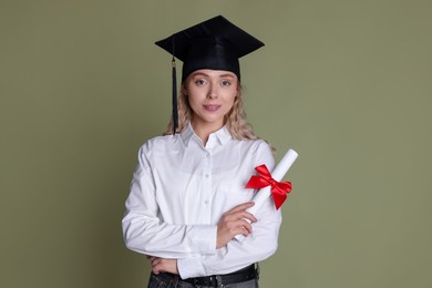 Photo of Happy student with diploma after graduation on green background