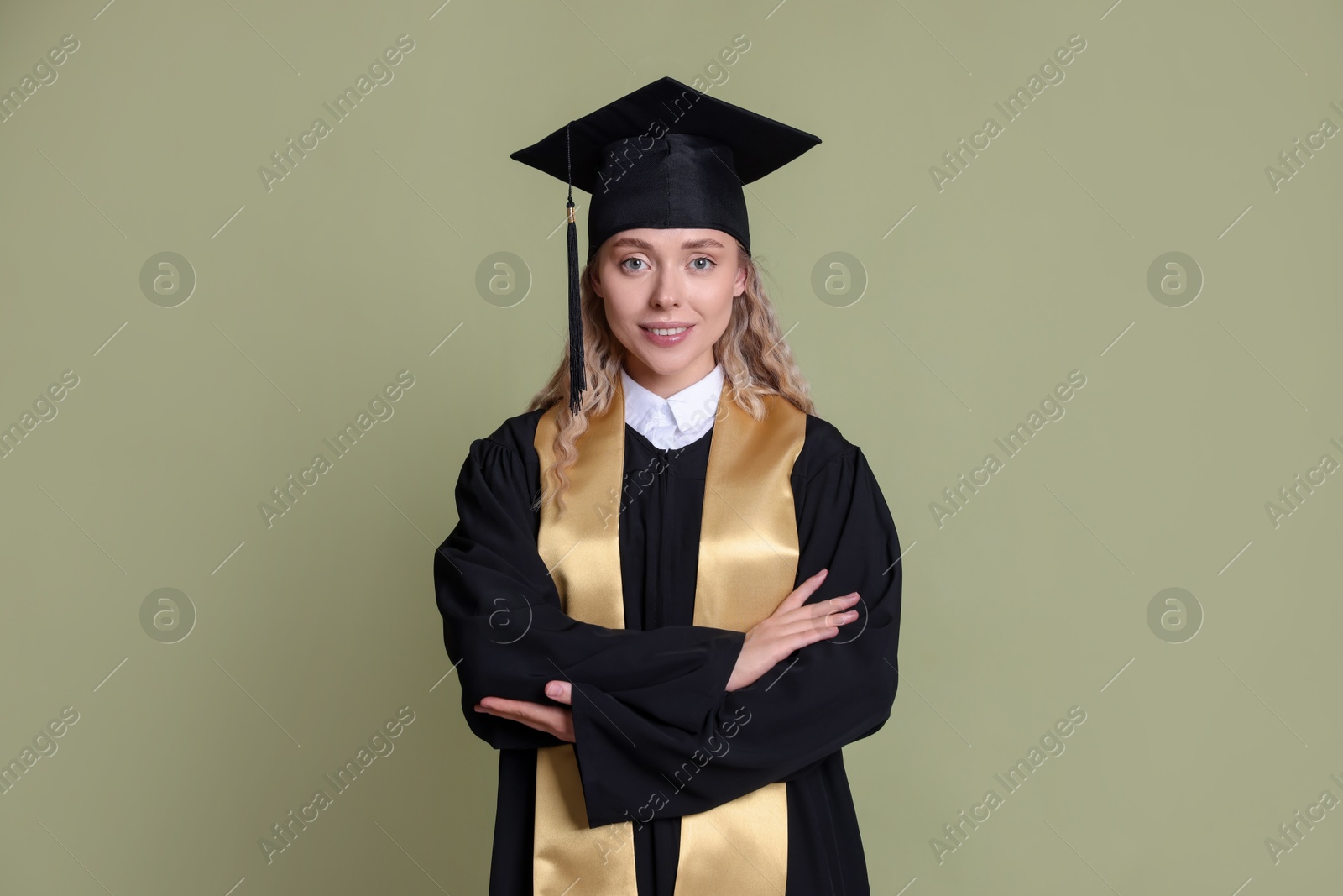 Happy student after graduation on green background Photo of Happy student after graduation on green background