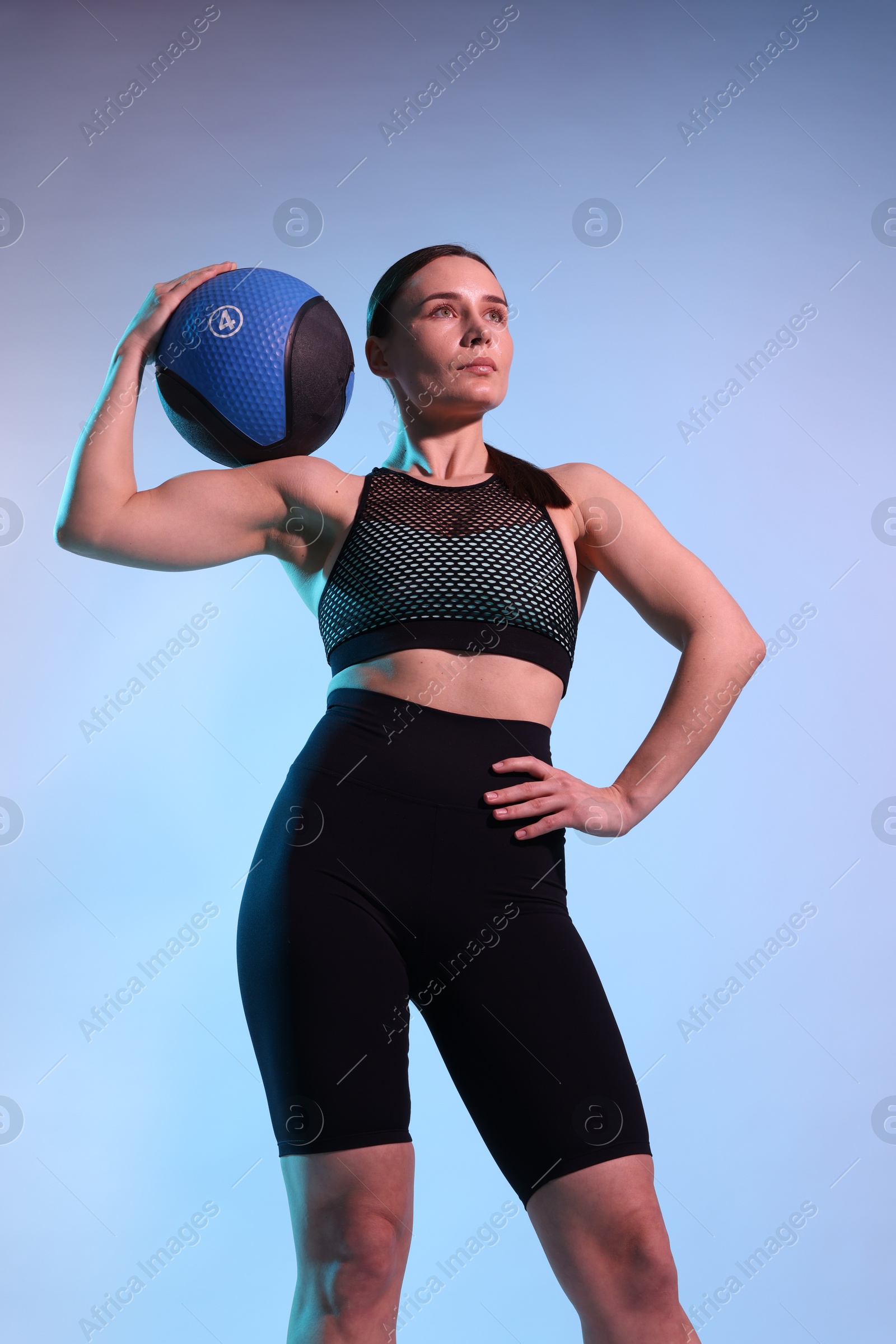 Woman with medicine ball on color background Photo of Woman with medicine ball on color background