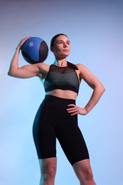 Photo of Woman with medicine ball on color background