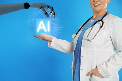 Image of Robot hand and doctor with virtual AI microchip against blue background, closeup. Artificial intelligence in medicine