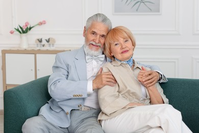 Photo of Lovely senior couple together on sofa at home