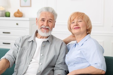 Photo of Lovely senior couple together on sofa at home