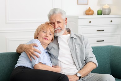 Photo of Lovely senior couple together on sofa at home