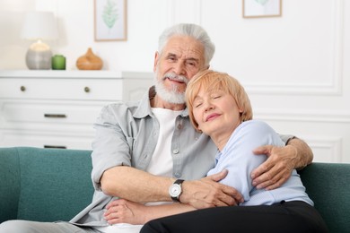 Photo of Lovely senior couple together on sofa at home