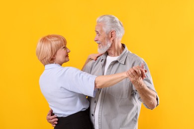Photo of Lovely senior couple together on yellow background