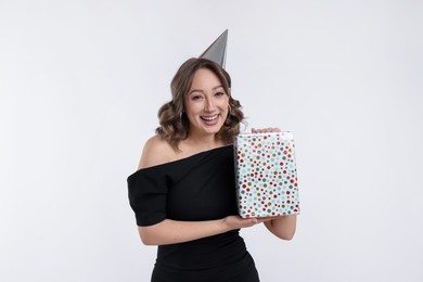 Photo of Birthday celebration. Woman with gift on white background