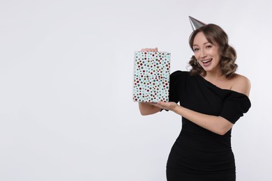 Photo of Birthday celebration. Woman with gift on white background. Space for text
