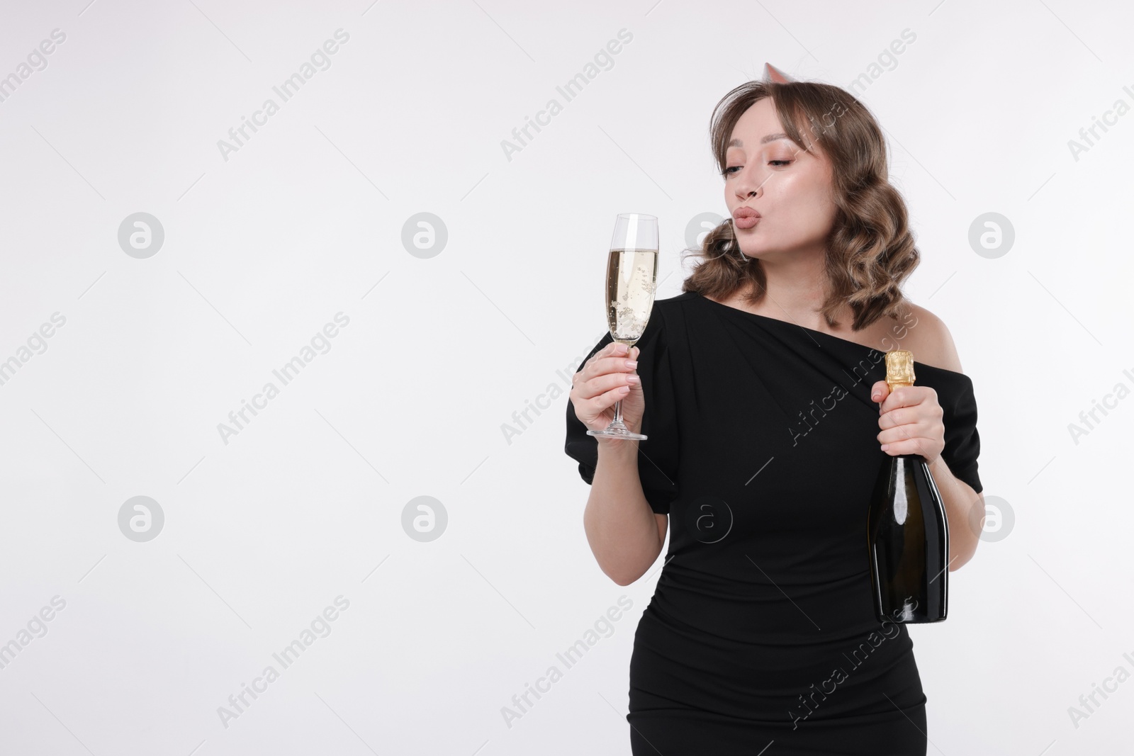 Photo of Birthday celebration. Woman with sparkling wine on white background. Space for text