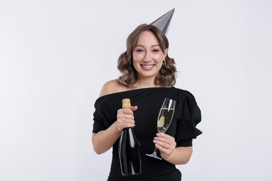 Photo of Birthday celebration. Woman with sparkling wine on white background
