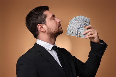 Photo of Greedy banker with dollar banknotes on golden background
