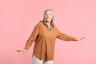 Photo of Senior woman in stylish outfit on pink background