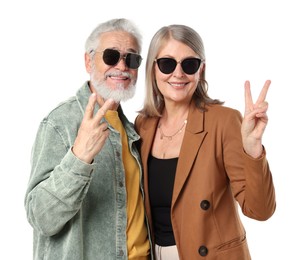 Photo of Senior couple in stylish outfits showing V-signs on white background