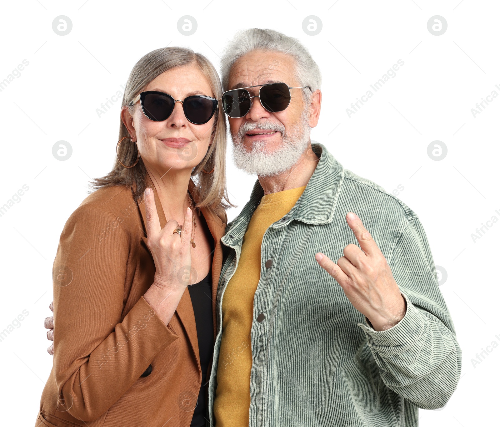 Senior couple in stylish outfits making rock gestures on white background Photo of Senior couple in stylish outfits making rock gestures on white background