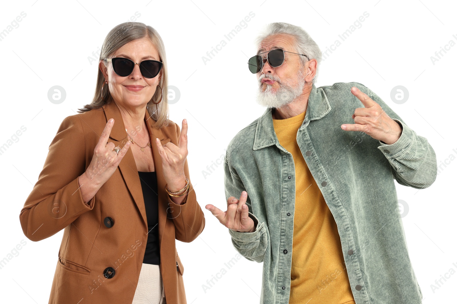 Senior couple in stylish outfits making rock gestures on white background Photo of Senior couple in stylish outfits making rock gestures on white background