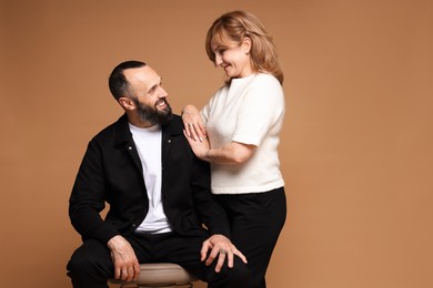 Photo of Portrait of lovely couple on brown background