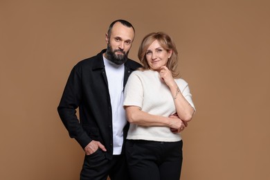 Photo of Portrait of lovely couple on brown background