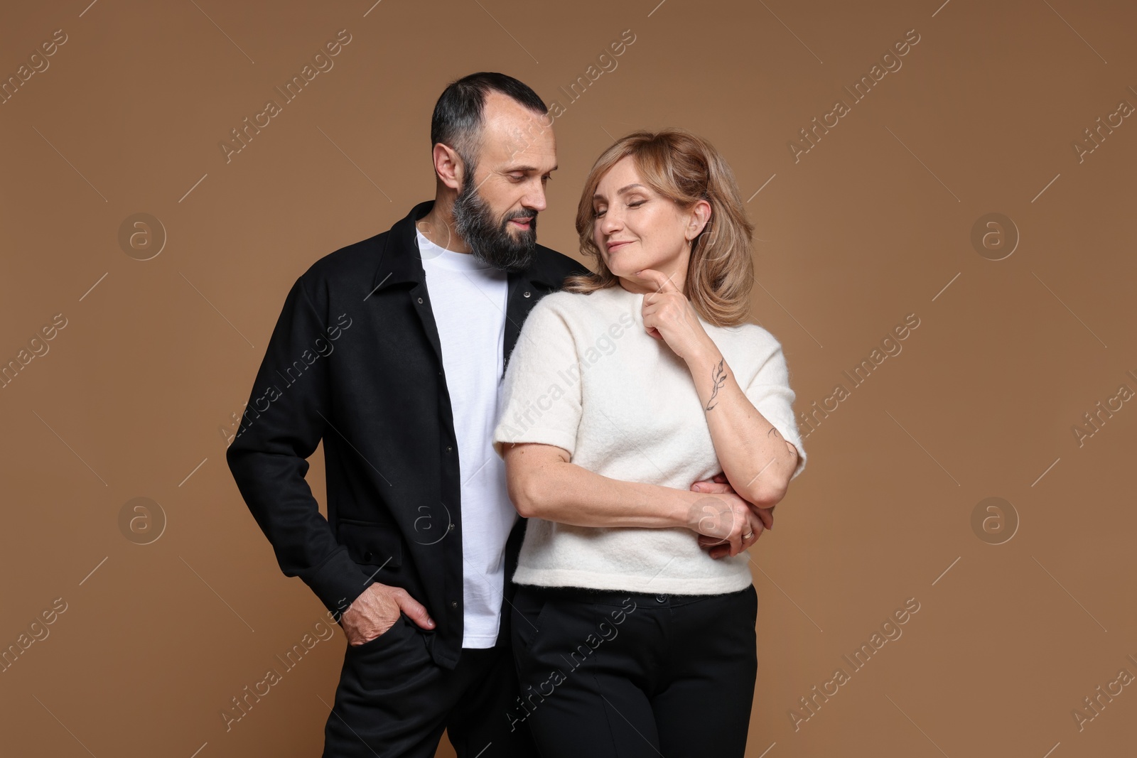 Photo of Portrait of lovely couple on brown background