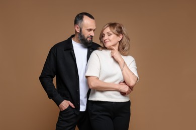 Photo of Portrait of lovely couple on brown background